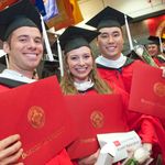 students smiling at graduation