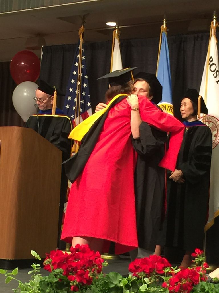 student and faculty member at graduation