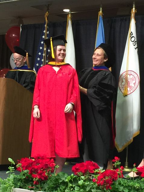 student and faculty at graduation