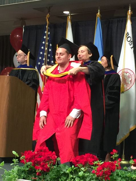 student and faculty member at graduation