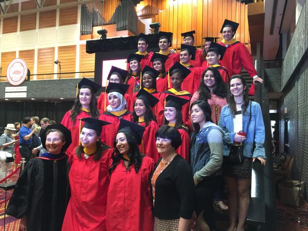 students and faculty at graduation