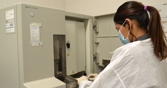 Student working with genetic analyzer in lab