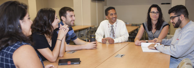 students and professor in discussion group