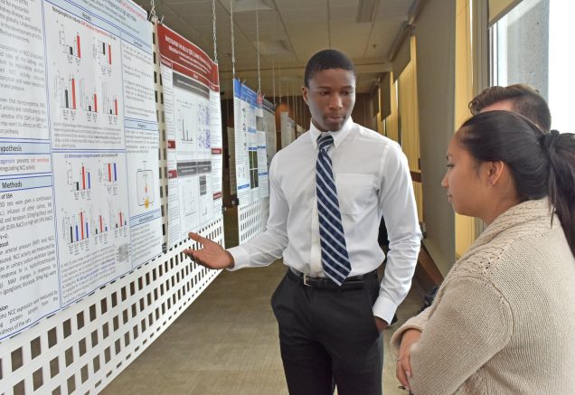 Man sharing his research at poster session