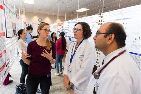 Photo of Evans Day - faculty in front of resident posters