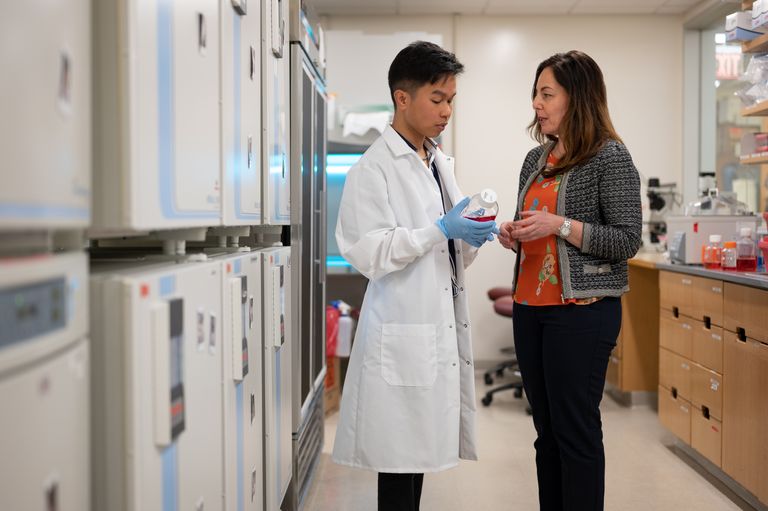 White coat speaking to researcher