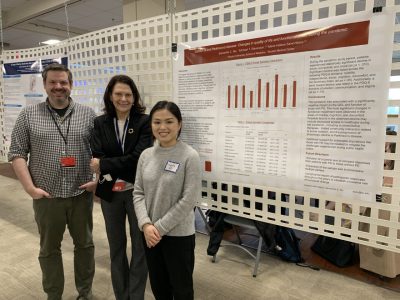 MDS Members Next to Research Poster