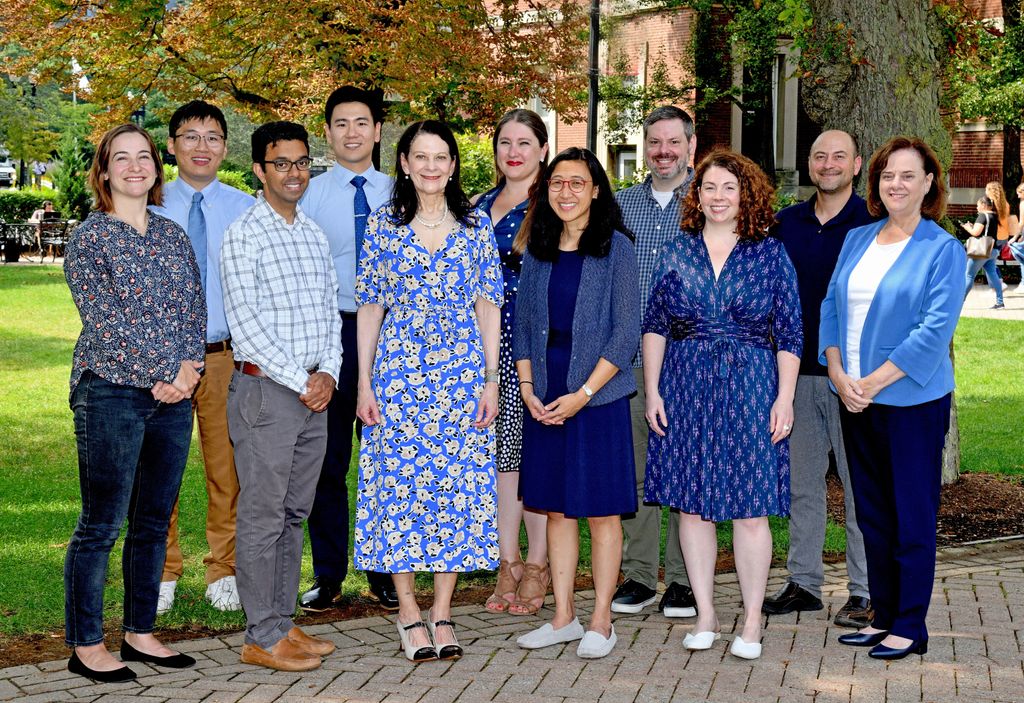 The Movement Disorder team smiles in front of the medical school on an early fall day.