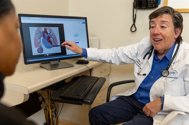 Dr. Liz Klings speaks with a patient. Photo credits: Boston Magazine